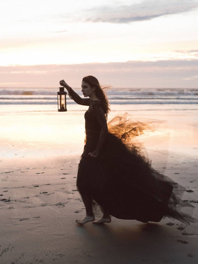 Girl with lantern on beach