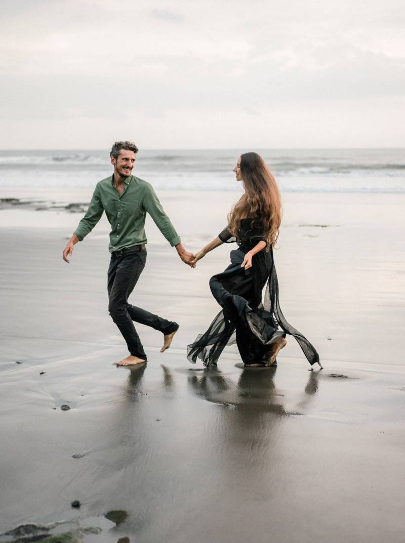 Emotive & moody engagement photos on a black sand beach