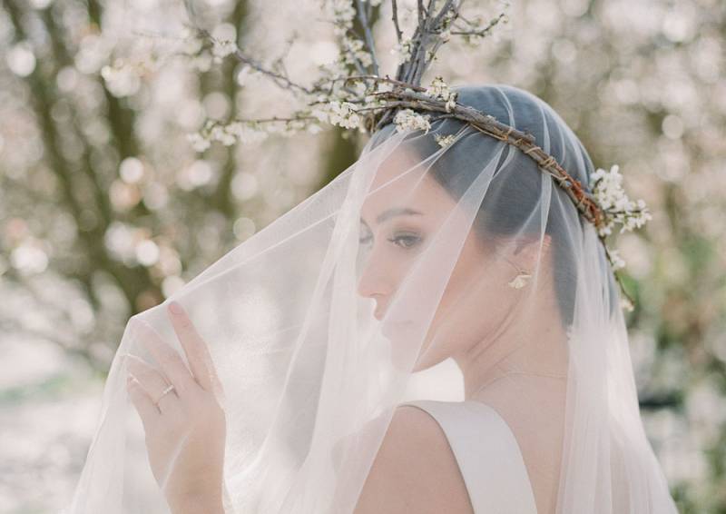 Romantic high fashion bridal inspiration in a blooming almond orchard