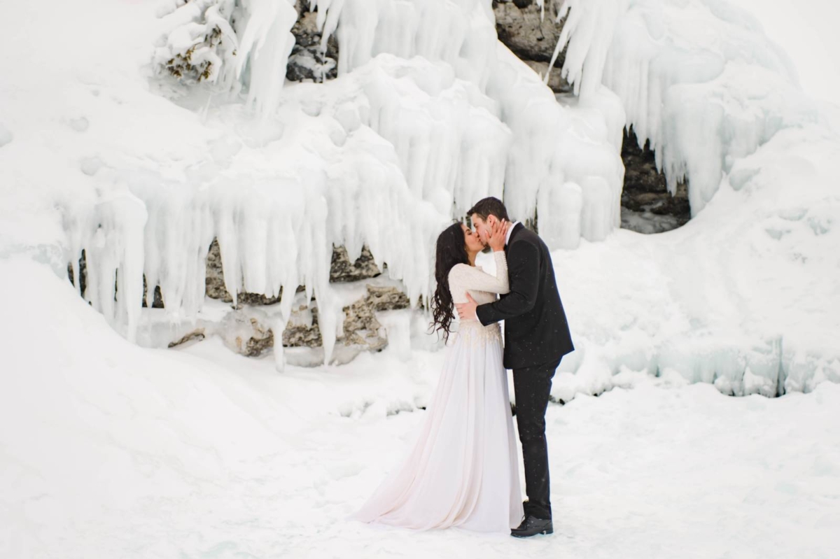 Winter elopement shoot amidst a frozen icy landscape